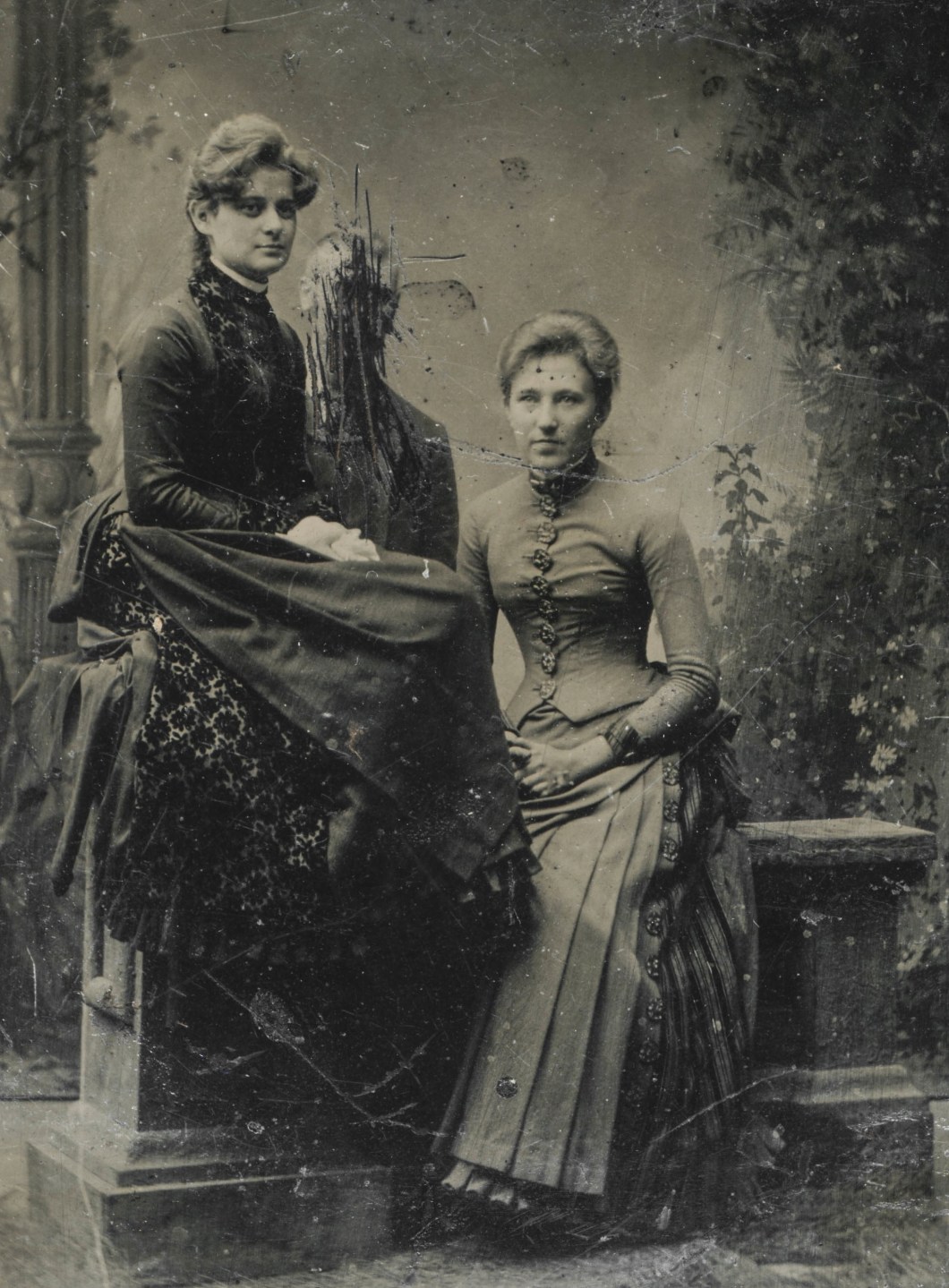 Tin type of two women and a scratched out man